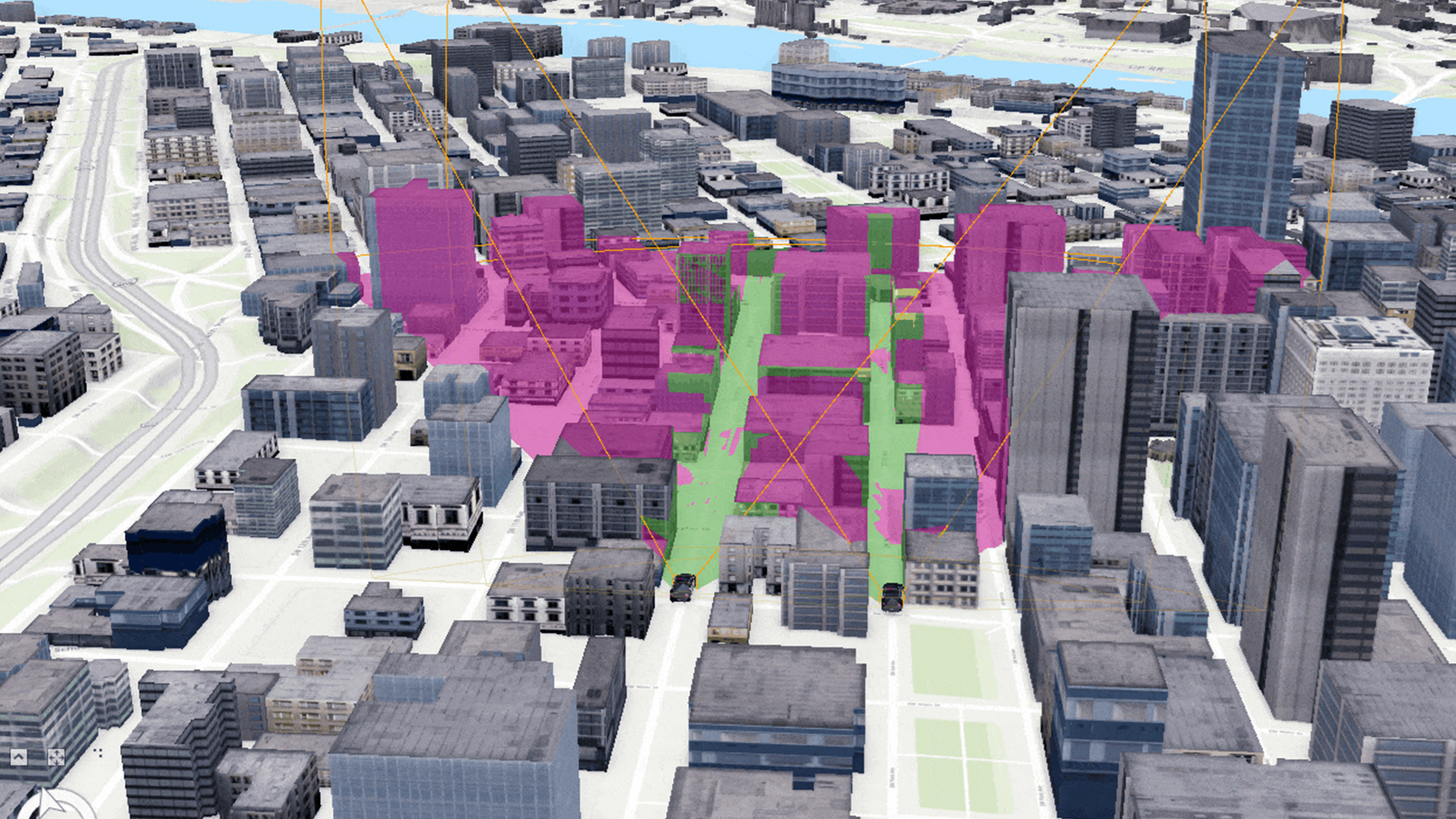 Ein 3D-Modell eines Stadtzentrums. Mehrere Gebäude sind in Rosa- und Grüntönen hervorgehoben, um Zonen oder Interessenbereiche innerhalb der Stadt zu kennzeichnen.